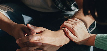 two women playing a hand game together at a table enjoying a moment of joy and connection pale blue laptop on the table representation of fun and creativity together 8 ways to bond 8 special moments